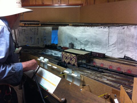 Operators running a train through Bec's Bend on Allen's layout